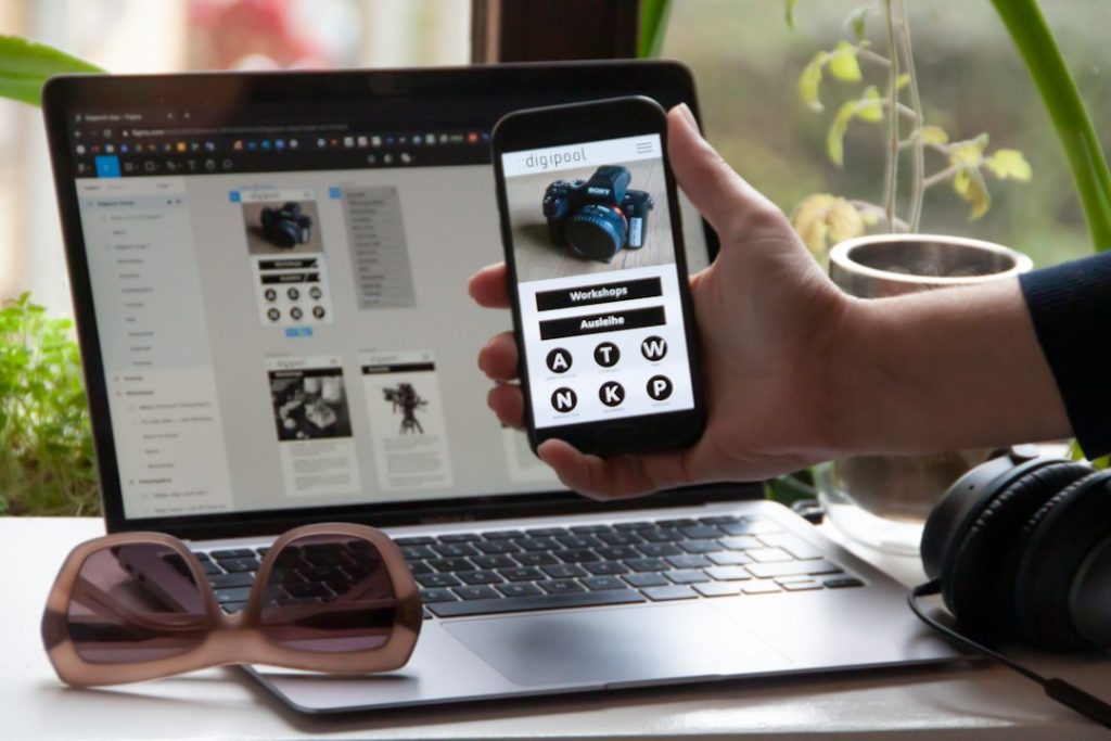 Person holding a phone showing a mobile-friendly website design