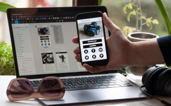 Person holding a phone showing a mobile-friendly website design
