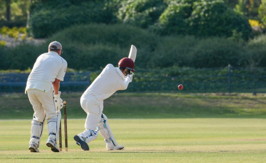 Cricket batsman playing a shot during a match