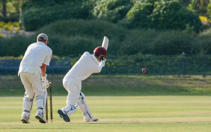 Cricket batsman playing a shot during a match