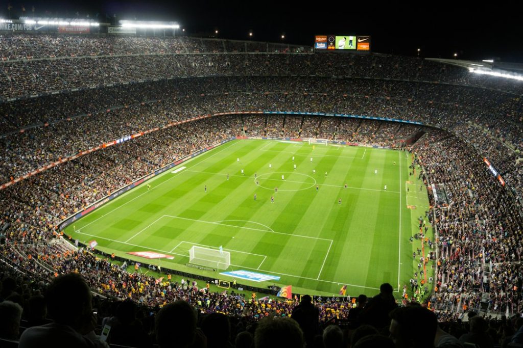 Packed football stadium during a night match