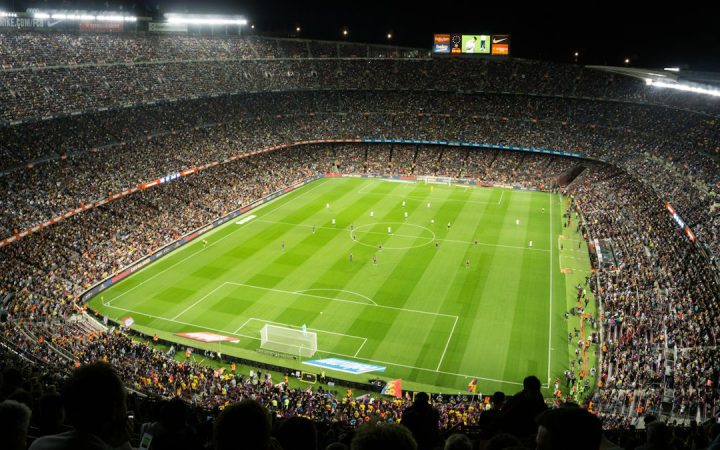 Packed football stadium during a night match