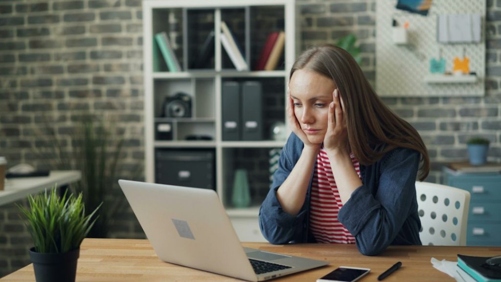 Tired office worker feeling stressed at desk