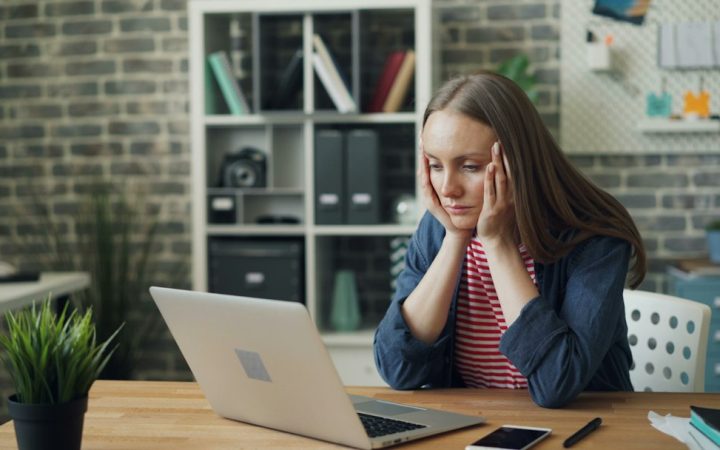 Tired office worker feeling stressed at desk